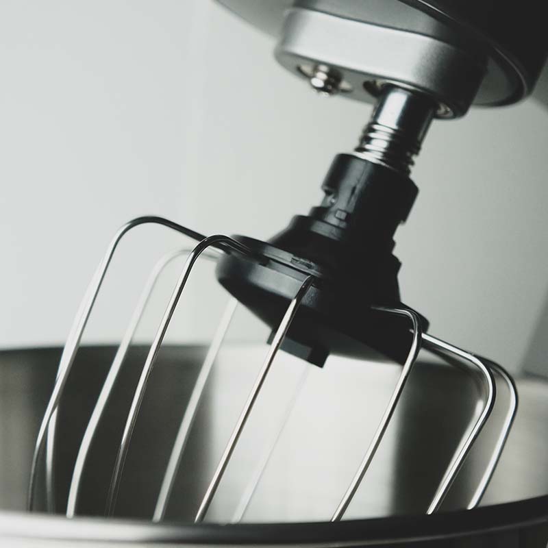 chrome-plated-planetary-mixer-whisk-bowl-close-up-gray-background-kitchen-helper